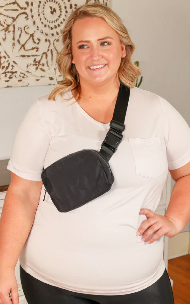 Woman wearing a black bum bag across her chest.