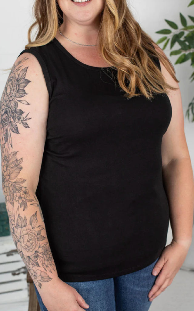 Woman wearing a classic black tank top.