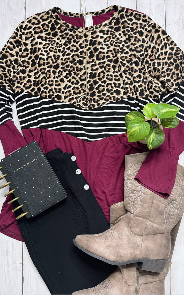 Flatlay photo of a women's colorblock shirt with animal print and stripes.