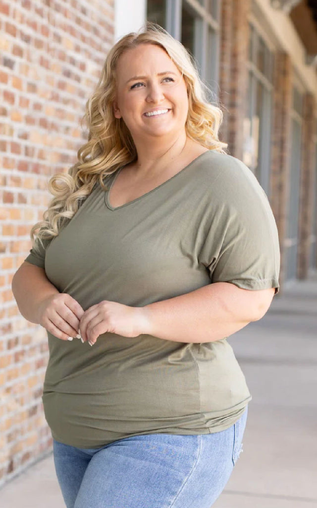 Woman wearing an olive green short sleeve tee.