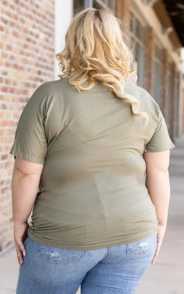 Woman wearing an olive green short sleeve tee.