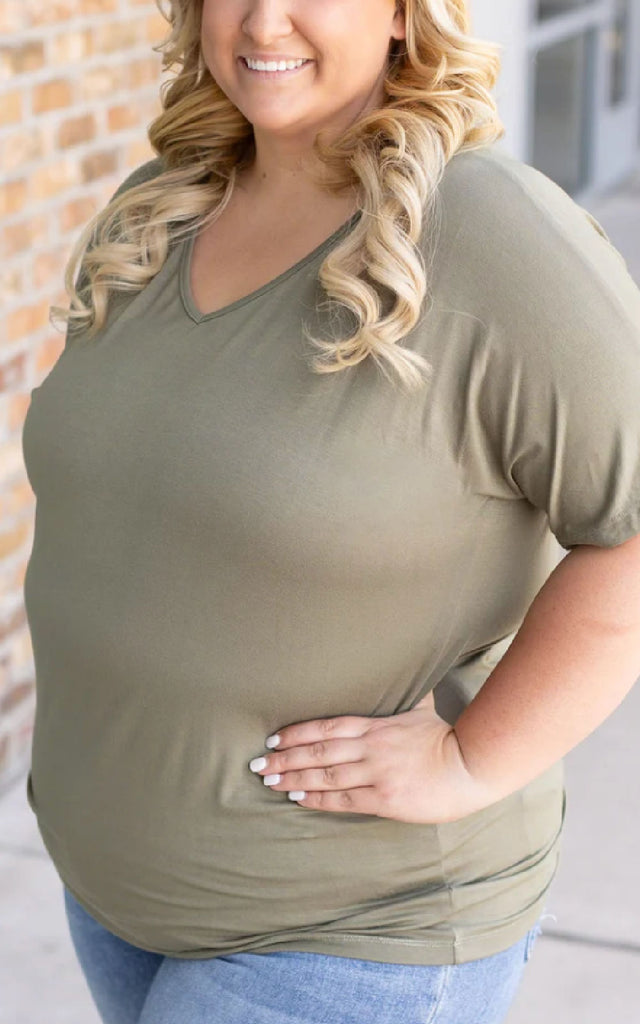 Woman wearing an olive green short sleeve tee.