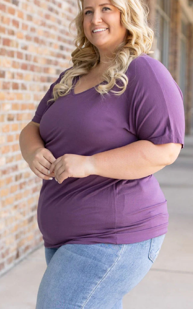 Woman wearing a casual short sleeve tee in purple.