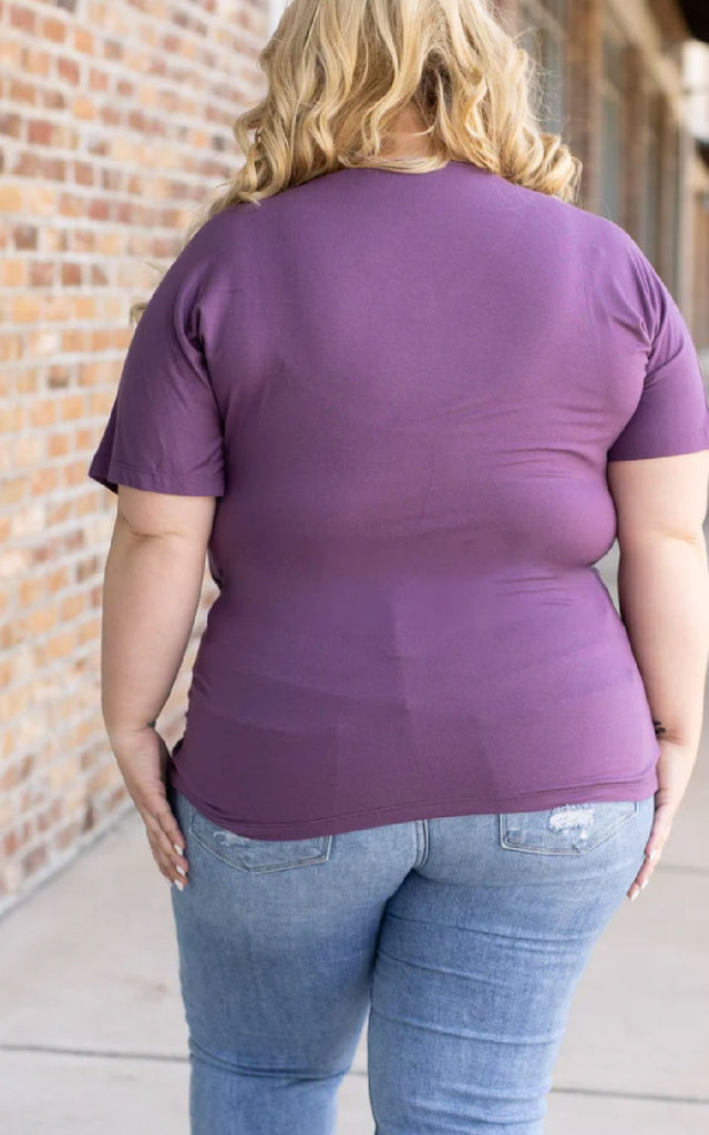 Woman wearing a casual short sleeve tee in purple.