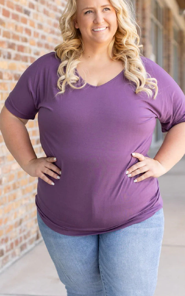 Woman wearing a casual short sleeve tee in purple.