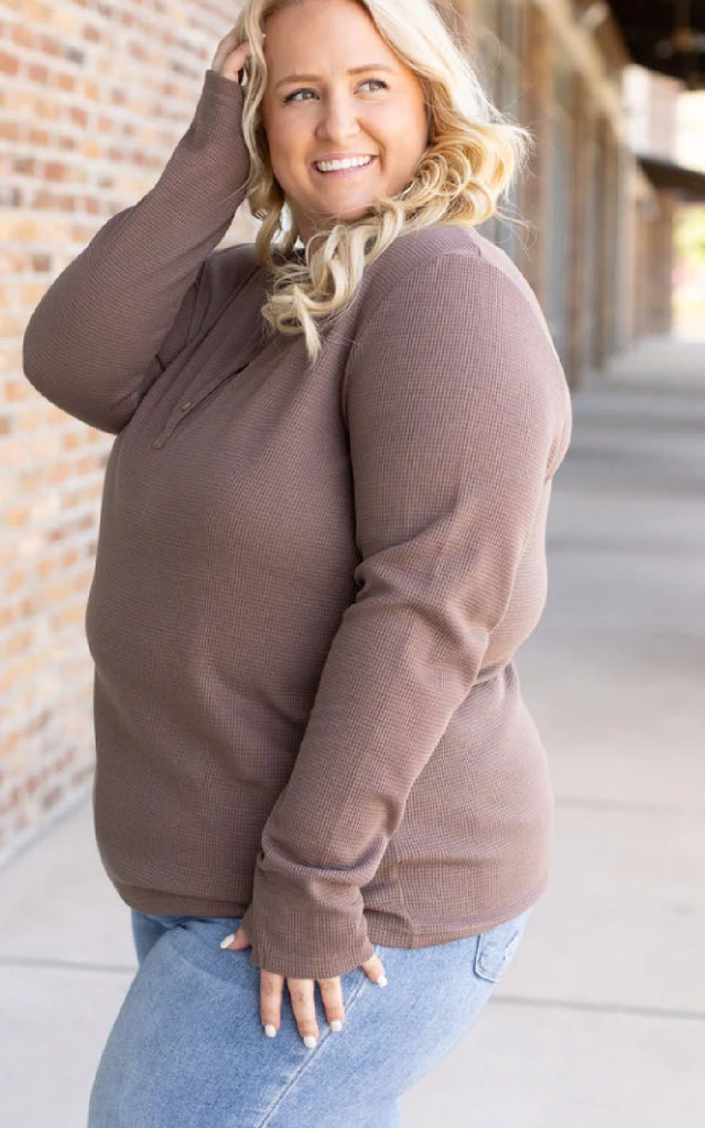 Woman wearing a mocha brown long sleeve waffle knit top.