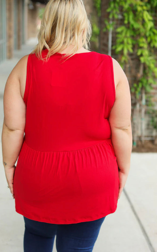 Woman wearing a loose and flowy red tank top.