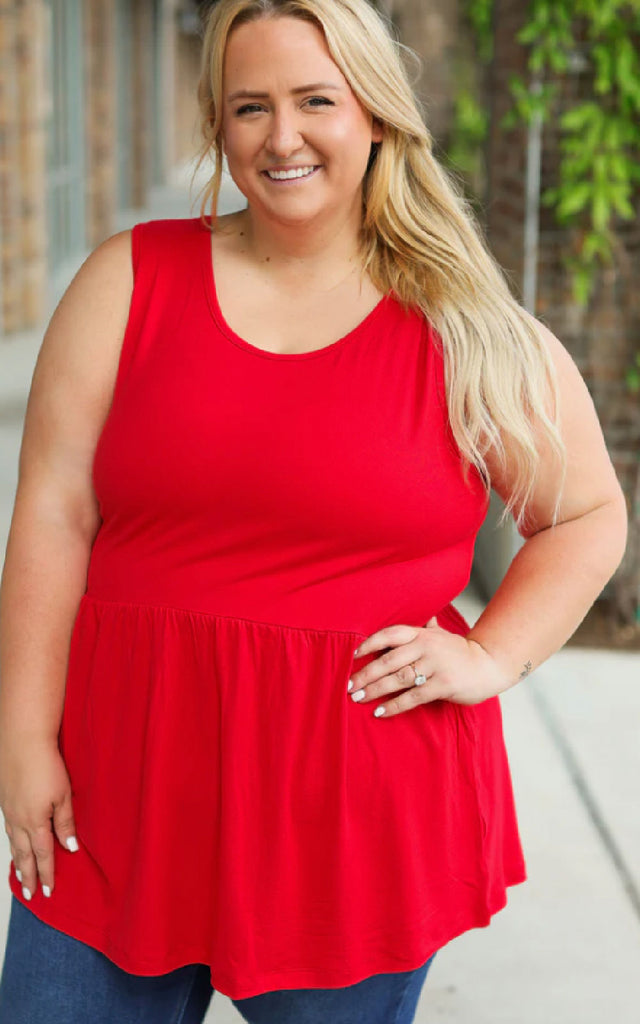 Woman wearing a loose and flowy red tank top.