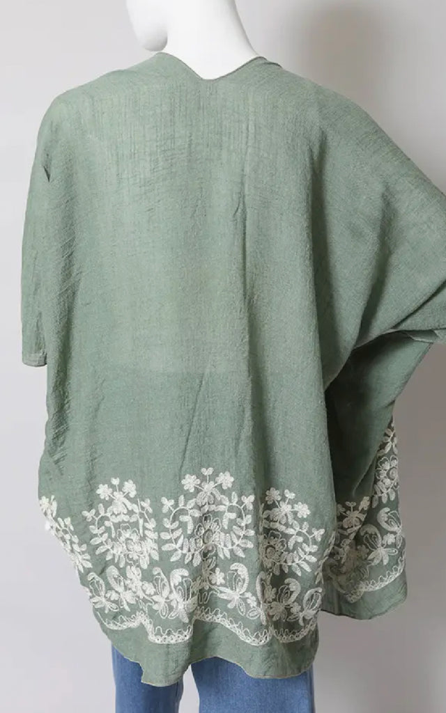 Women's Floral Stitch Ruana with Embroidered Flowers at the hem.